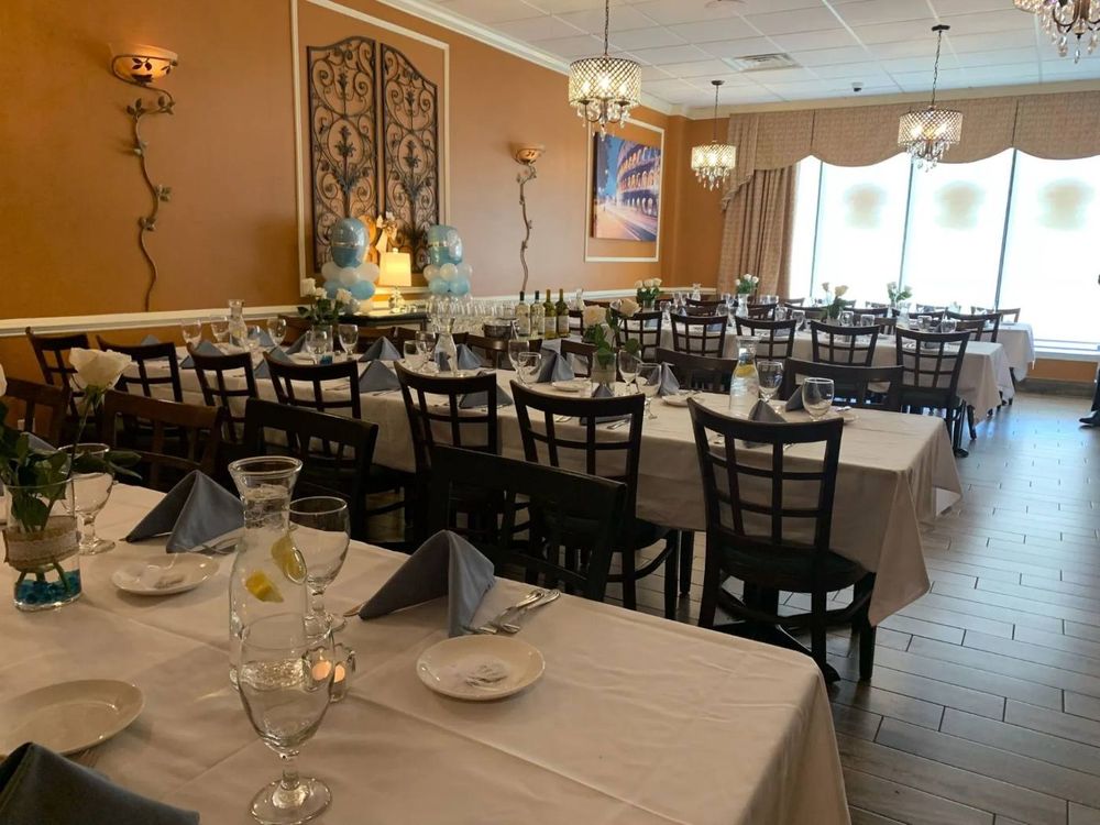 Banquet room with long tables set in white and pink